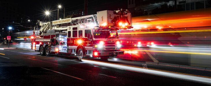 fire truck driving with lights on at night